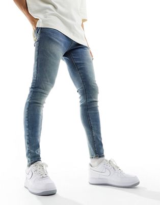 ASOS DESIGN spray on jeans in tinted mid wash blue
