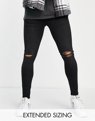 ASOS DESIGN spray on jeans with power stretch in black with busted knee