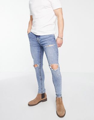 ASOS DESIGN spray on jeans with power stretch in mid wash with knee rips and abrasions-Blue
