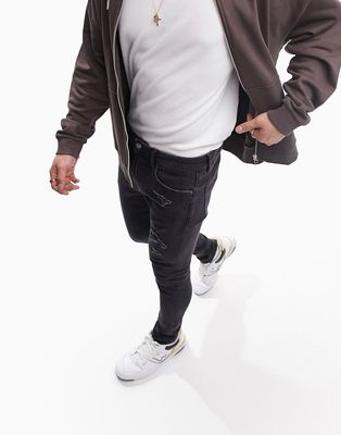 ASOS DESIGN spray on jeans with power stretch with abrasions and raw hem in washed black