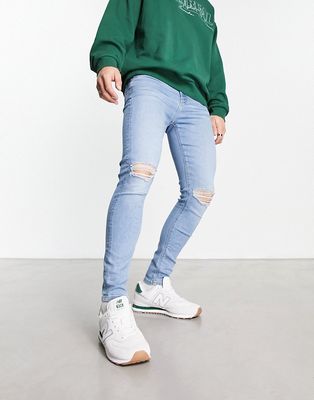 ASOS DESIGN spray on jeans with powerstretch in light wash blue with knee rips