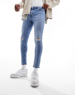 ASOS DESIGN spray on jeans with powerstretch in mid blue with knee rips