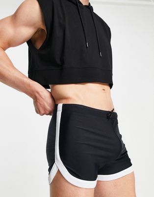 ASOS DESIGN swim briefs with curved hem and white binding in black
