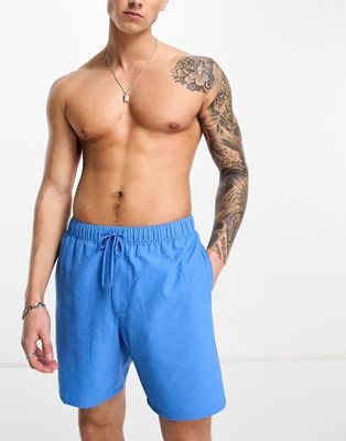 ASOS DESIGN swim shorts in mid length in seersucker blue