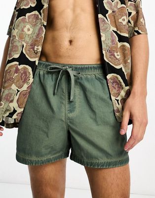 ASOS DESIGN swim shorts in short length in washed green