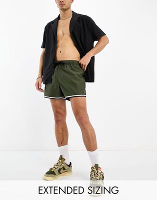 ASOS DESIGN swim shorts in short length with cargo pocket and contrast binding in khaki-Green