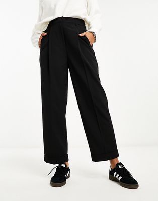 ASOS DESIGN tapered pants with turn up hem in black