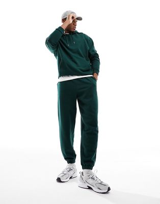 ASOS DESIGN tracksuit with oversized hoodie and sweatpants in dark green