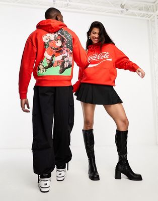 ASOS DESIGN unisex license oversized hoodie in red with Coca Cola Santa Christmas print