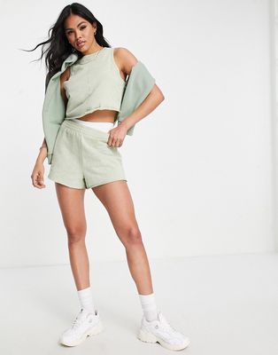 ASOS DESIGN washed runner shorts with raw hem in lime-Green