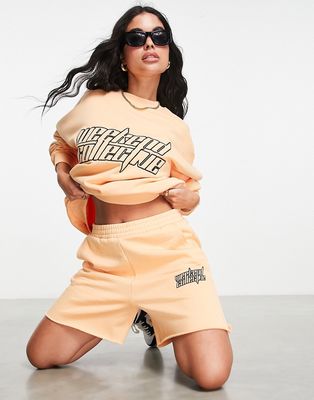ASOS Weekend Collective sweat shorts with futuristic logo in apricot - part of a set-Orange