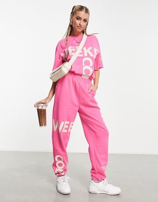 ASOS Weekend Collective sweatpants with cut about graphic in pink
