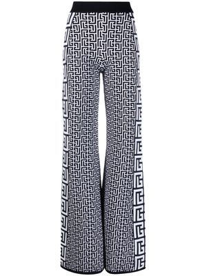 Balmain monogram-pattern flared trousers - White
