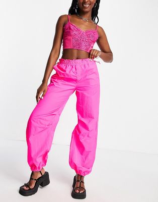 Bershka baggy parachute tech pants in pink