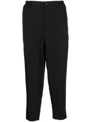 Black Comme Des Garçons tapered cropped trousers