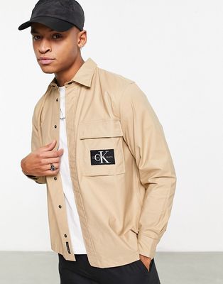 Calvin Klein Jeans badge logo long sleeve shirt in beige-Neutral