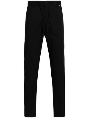 Calvin Klein logo-patch tapered trousers - Black