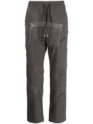 Children Of The Discordance logo-embroidered distressed track pant - Grey