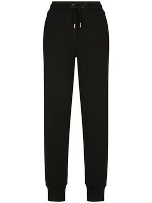 Dolce & Gabbana logo-embossed cotton track pants - Black