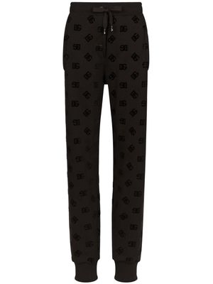 Dolce & Gabbana logo-flocked cotton track pants - Black