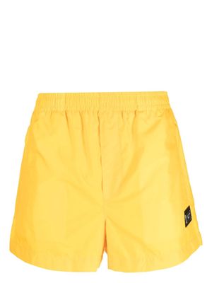 Dolce & Gabbana logo-patch elasticated swim shorts - Yellow
