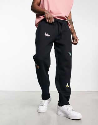 Good For Nothing oversized straight leg sweatpants in black with butterfly placement prints and hem split - part of a set