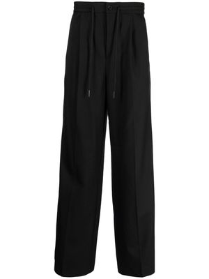 Holzweiler pressed-crease tailored trousers - Black