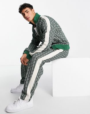 Lacoste all-over print taped track pants in green