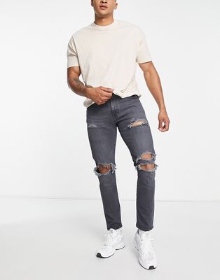 Levi's 512 slim taper jeans with distressing in black wash