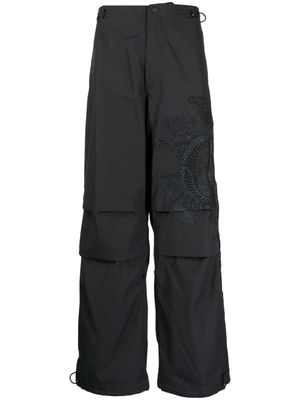 Maharishi graphic-print wide-leg trousers - Black