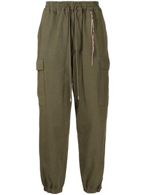 Mastermind World logo-embroidered tapered-leg trousers - Green