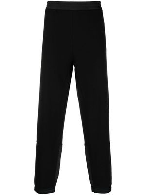 Moncler logo-print contrasting-panel trousers - Black