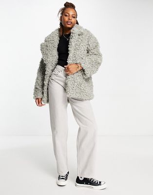 Monki curly faux fur jacket in gray-Neutral