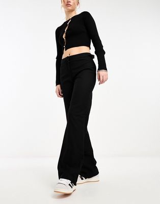 Monki low waisted pants with side buckle detail in black