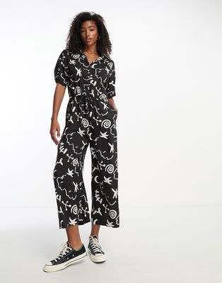 Monki tie waist jumpsuit in black and white face and moon print-Multi