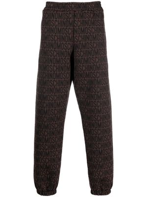 Moschino all-over embroidered logo track pants - Brown