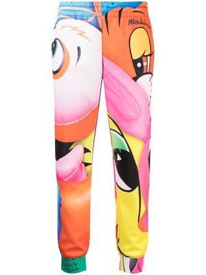 Moschino all-over graphic-print trousers - Pink
