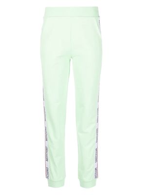 Moschino embossed-logo jersey trousers - Green