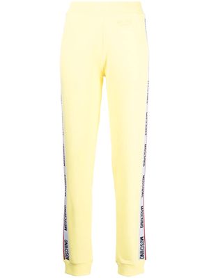 Moschino embossed-logo jersey trousers - Yellow