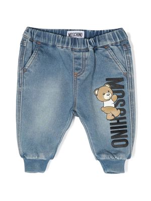 Moschino Kids Teddy Bear-motif logo-patch tapered jeans - Blue
