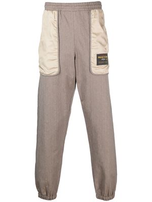 Moschino logo-patch panelled track pants - Brown