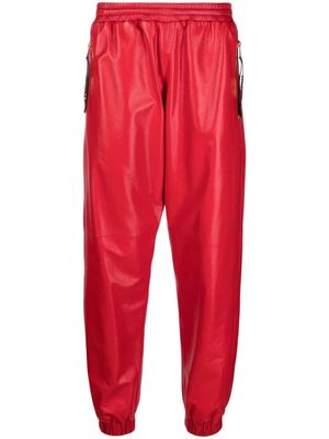 Moschino logo-plaque leather track pants - Red