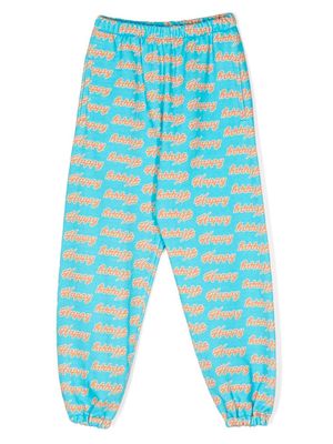 Natasha Zinko Kids Happy-print track pants - Blue