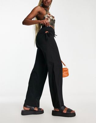 Neon & Nylon low waisted pants with cut out detail in black