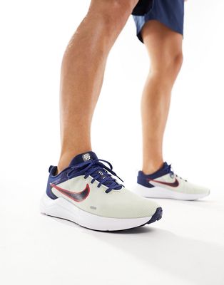 Nike Downshifter 12 sneakers in white and navy