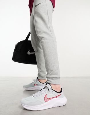 Nike Legend Essential 3 sneakers in gray and red