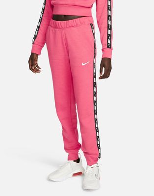 Nike Tape Pack regular fit cuffed fleece sweatpants in dusty pink-Red