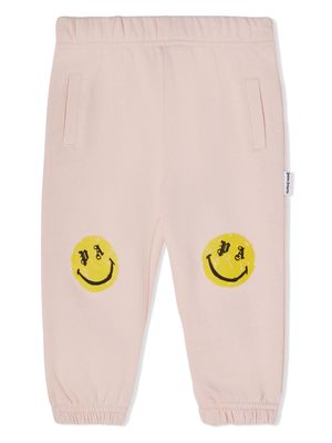 Palm Angels Kids smiley face-print track pants - Pink