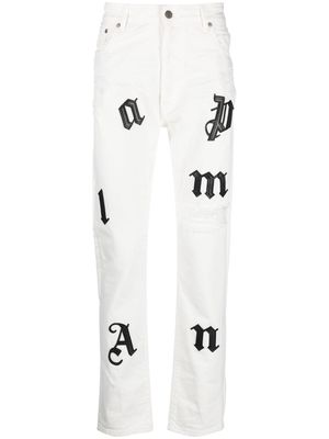 Palm Angels logo-patch distressed jeans - White