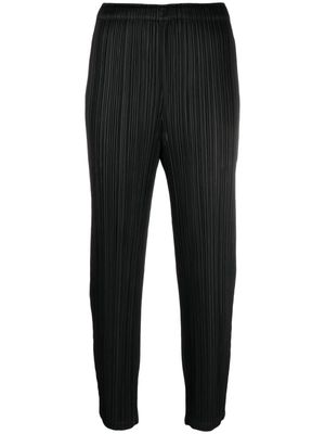 Pleats Please Issey Miyake pleated tapered trousers - Black